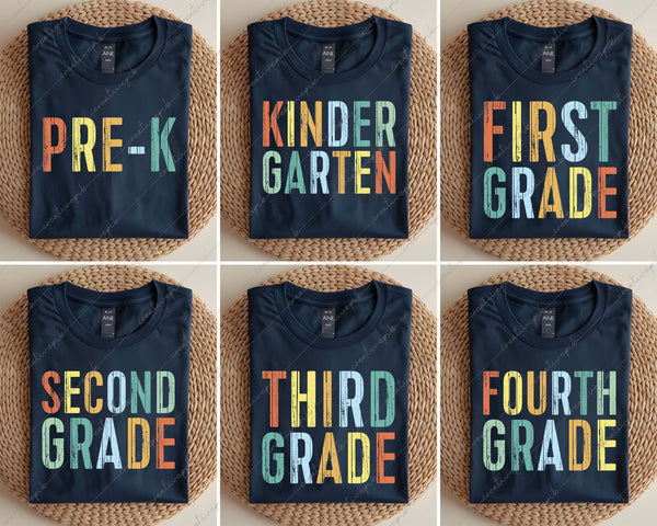Set of six navy blue t-shirts with colorful grade-level text on a woven surface.
