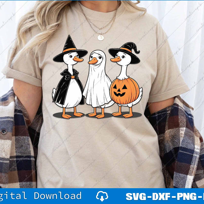 Person wearing a t-shirt with Halloween-themed duck designs and plaid jacket.