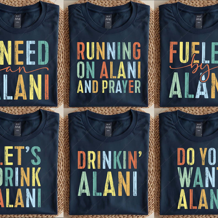 Six black t-shirts with colorful text on a woven surface